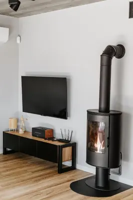 a fireplace in a living room with a tv at Tarnova Chill in Tarnawa