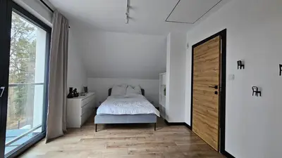 a bedroom with a bed and a large window at Tarnova Chill in Tarnawa