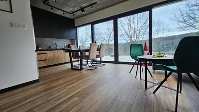 a kitchen and dining room with a table and chairs at Tarnova Chill in Tarnawa
