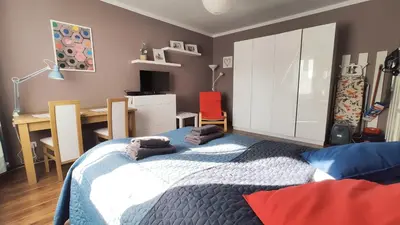 a bedroom with a bed and a desk and a table at Blachnickiego 9 by Homeprime in Kraków