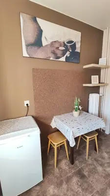 a small table and two chairs in a room at Blachnickiego 9 by Homeprime in Kraków
