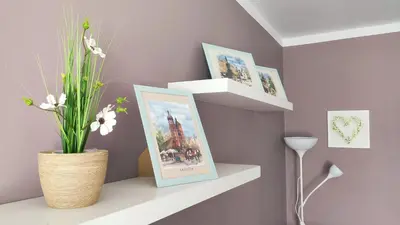 a shelf with pictures and a vase with flowers on it at Blachnickiego 9 by Homeprime in Kraków