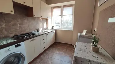 a kitchen with a washing machine and a sink at Blachnickiego 9 by Homeprime in Kraków