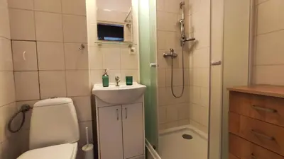 a bathroom with a toilet and a sink and a shower at Blachnickiego 9 by Homeprime in Kraków
