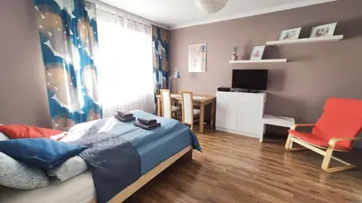 a bedroom with a bed and a desk and a chair at Blachnickiego 9 by Homeprime in Kraków