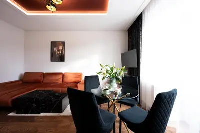 a chandelier hanging from the ceiling in a room at Native Apartments Słowackiego 14 Deluxe in Kraków