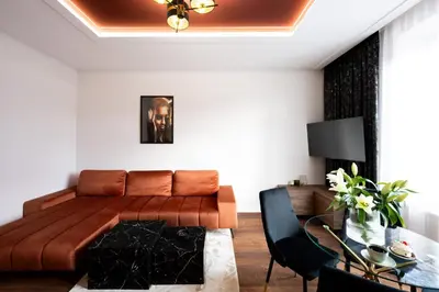 a dining room with a glass table and black chairs at Native Apartments Słowackiego 14 Deluxe in Kraków