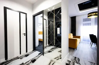 a bathroom with a mirror and a sink at Native Apartments Słowackiego 14 Superior in Kraków