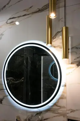 a round mirror on a wall in a room at Native Apartments Słowackiego 14 Superior in Kraków