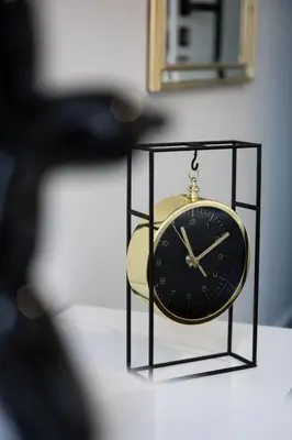 a clock sitting on top of a table at Native Apartments Słowackiego 14 Superior in Kraków