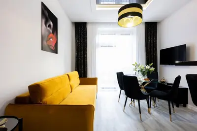 a bedroom with a white bed and two lamps at Native Apartments Słowackiego 14 Superior in Kraków
