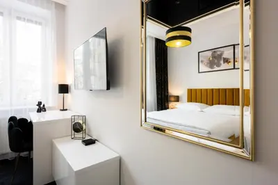 a living room with a glass table and black chairs at Native Apartments Słowackiego 14 Superior in Kraków