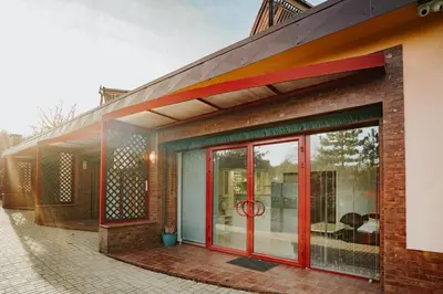 a facade of a building with glass doors at Apartamenty Pod Dzwonkiem in Wadowice