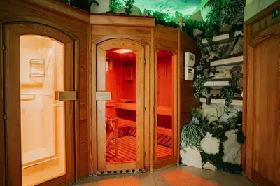 a room with a wooden closet with red doors at Apartamenty Pod Dzwonkiem in Wadowice
