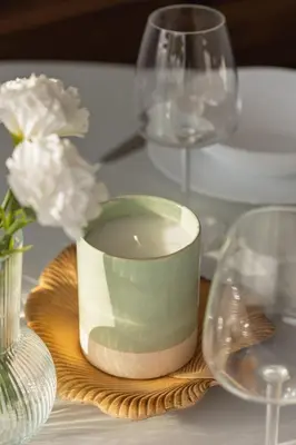 a table with glasses and a candle on a plate at Comfortable Two-Bedroom Apartment Strzelców by Noclegi Renters in Kraków