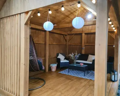 a living room with wood paneling and blue lights at Apartamenty na Maciejową in Rabka-Zdroj