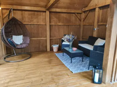 a living room with a couch and a swing at Apartamenty na Maciejową in Rabka-Zdroj