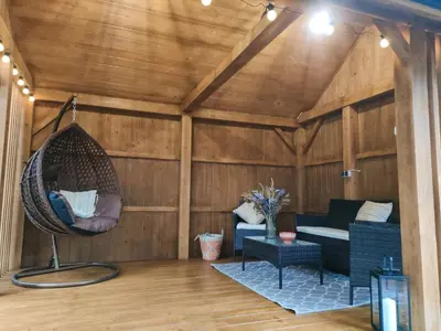 a living room with a couch and a swing at Apartamenty na Maciejową in Rabka-Zdroj