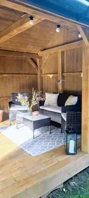 a patio with two couches and a table at Apartamenty na Maciejową in Rabka-Zdroj