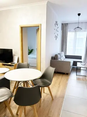 a living room with a table and chairs and a couch at Deluxe residence apartment in Kraków