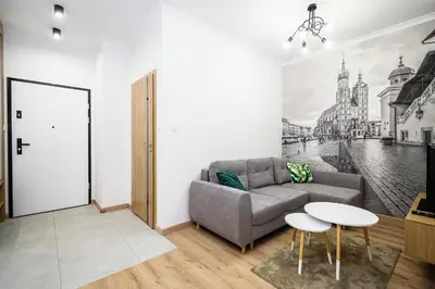 a living room with a couch and a table at Deluxe residence apartment in Kraków