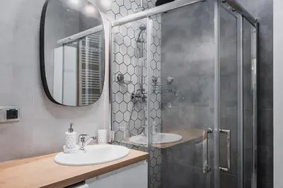 a bathroom with two sinks and a shower at Deluxe residence apartment in Kraków