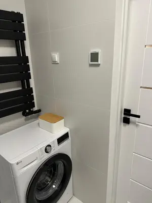 a washer and dryer in a small room at M&S Apartment in Kraków