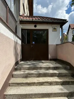 a set of stairs leading to a brown door at M&S Apartment in Kraków
