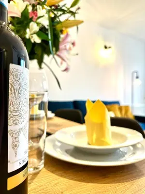 a bottle of wine and a plate of cheese on a table at COZY OLD-Town Apartments at Kazimierz +AC, KITCHEN and NETFLIX in Kraków