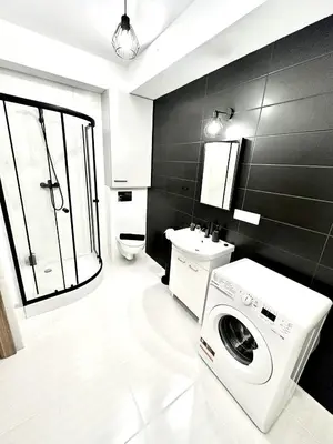 a bathroom with a washing machine and a sink at COZY OLD-Town Apartments at Kazimierz +AC, KITCHEN and NETFLIX in Kraków