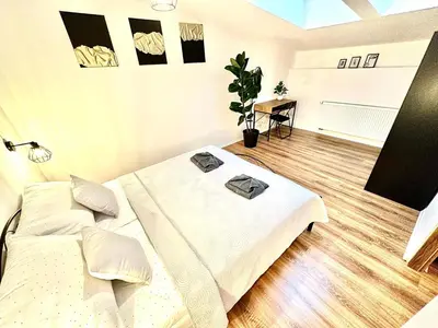 a bedroom with two beds and a table in it at COZY OLD-Town Apartments at Kazimierz +AC, KITCHEN and NETFLIX in Kraków