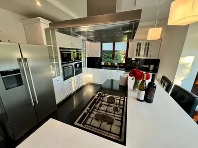 a kitchen with a stove and a white counter top at Uroczysko pod Mogielicą in Szczawa