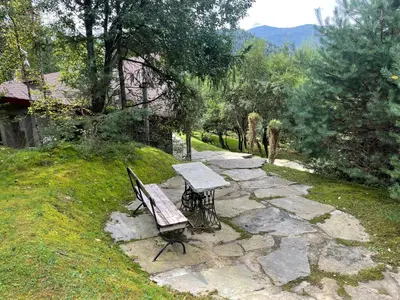 a bench and a table on a stone path at Uroczysko pod Mogielicą in Szczawa