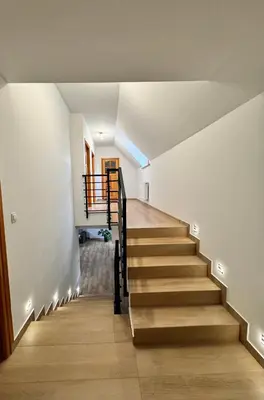 a staircase in a house with wooden floors at Apartament w Budzowie in Budzów