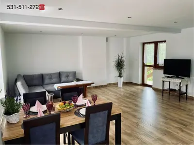 a living room with a table and a couch at Apartament w Budzowie in Budzów