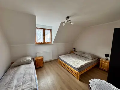 a bedroom with two beds and a window at Apartament w Budzowie in Budzów