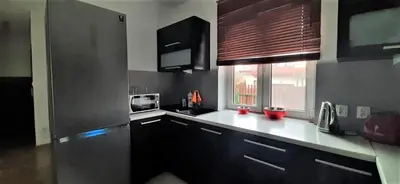 a kitchen with a black refrigerator and a window at House between Cracow and Wieliczka in Wieliczka