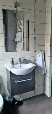 a bathroom with a sink and a mirror at House between Cracow and Wieliczka in Wieliczka