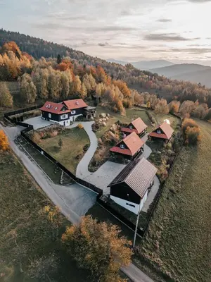 an aerial view of a house in a forest at U Pana Boga za piecem - domki w górach, Sauna, Beskidy, Koszarawa in Korbielów
