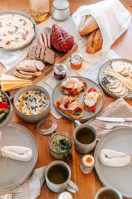 a table topped with plates of food and bread at U Pana Boga za piecem - domki w górach, Sauna, Beskidy, Koszarawa in Korbielów