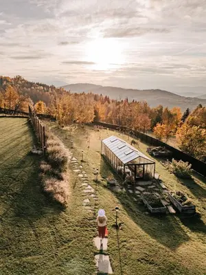 an aerial view of a farm with a building at U Pana Boga za piecem - domki w górach, Sauna, Beskidy, Koszarawa in Korbielów