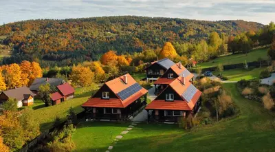 an aerial view of a house on a hill at U Pana Boga za piecem - domki w górach, Sauna, Beskidy, Koszarawa in Korbielów