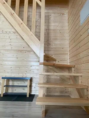 a wooden staircase in a sauna with a bench at Widokowe Stodoły balia z hydromasażem na wylączność in Chyszówki