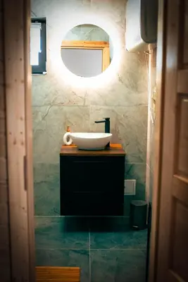 a bathroom with a sink and a mirror at Widokowe Stodoły balia z hydromasażem na wylączność in Chyszówki