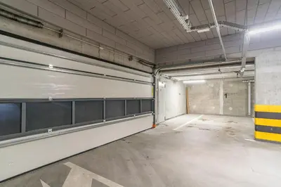 an empty parking garage with a bunch of stalls at Tauron Arena Modern Apartment - Parking and Balcony by Rentujemy in Kraków