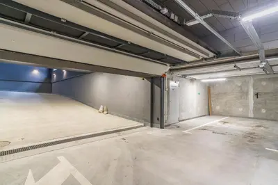 an empty parking lot in a parking garage at Tauron Arena Modern Apartment - Parking and Balcony by Rentujemy in Kraków