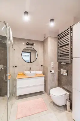 a bathroom with a sink and a toilet and a mirror at Tauron Arena Modern Apartment - Parking and Balcony by Rentujemy in Kraków