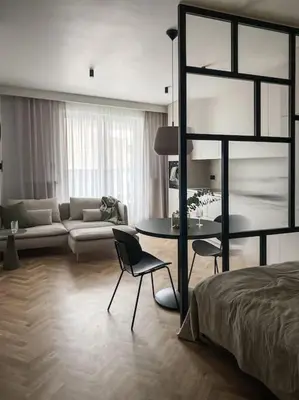 a living room with a bed and a table and a couch at Apartament BonHaus WiślaneTarasy in Kraków