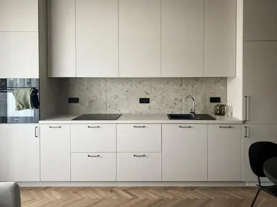 a white kitchen with white cabinets and a sink at Apartament BonHaus WiślaneTarasy in Kraków