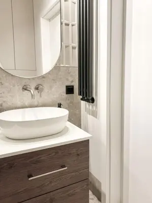 a bathroom with a white sink and a mirror at Apartament BonHaus WiślaneTarasy in Kraków
